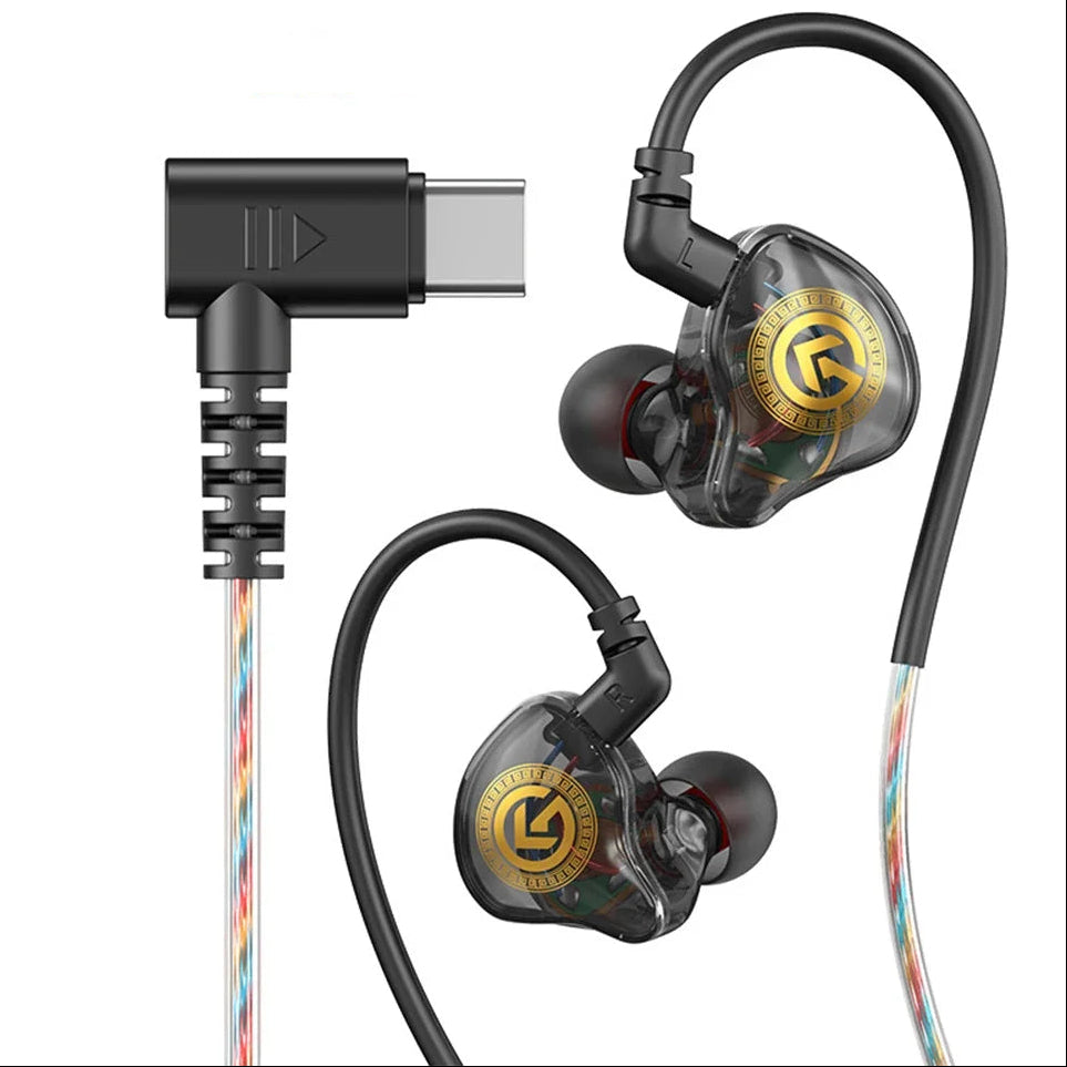 A pair of in-ear monitors with transparent housing, gold and black branding, black ear hooks, and multicolor braided cables, shown with a USB-C to right-angle adapter on a white background.